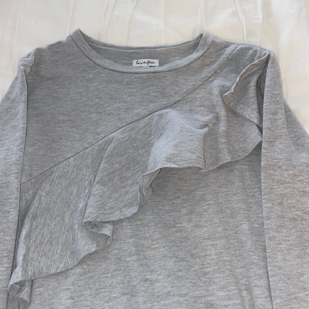 gray dress with ruffles across the front